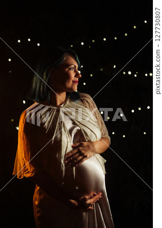 Beautiful pregnant woman in silky satin dress.Elegant maternity, wedding, bride Beautiful pregnant woman in silky satin dress.Elegant maternity, wedding, bride 127730807