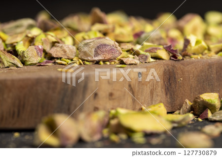 fried pistachios peeled from the shell, salted crunchy nuts, pistachios without shells, cut into small and large pieces fried pistachios peeled from the shell, salted crunchy nuts, pistachios without shells, cut into small and large pieces 127730879
