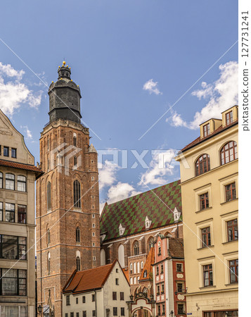 Historic St. Elisabeth Church Tower and Colorful Buildings Against a Bright Blue Sky Historic St. Elisabeth Church Tower and Colorful Buildings Against a Bright Blue Sky 127731241