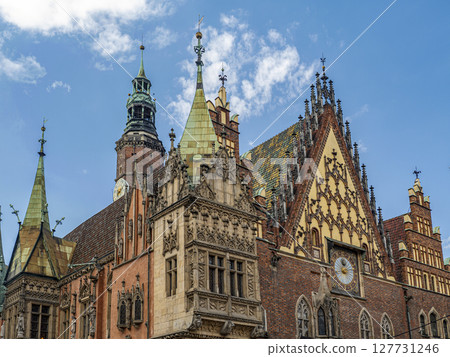 Gothic Architecture of Historic European Town Hall Building Against a Blue Sky, Wroclaw, Poland Gothic Architecture of Historic European Town Hall Building Against a Blue Sky, Wroclaw, Poland 127731246