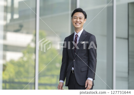 Smiling businessman in his 40s Smiling businessman in his 40s 127731644