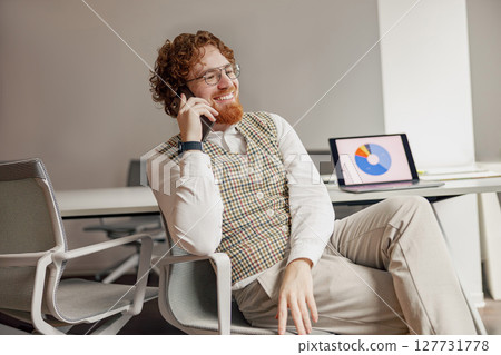 Businessman Dressed in Smart Casual Attire Engaged in a Phone Call for Business Purposes 127731778