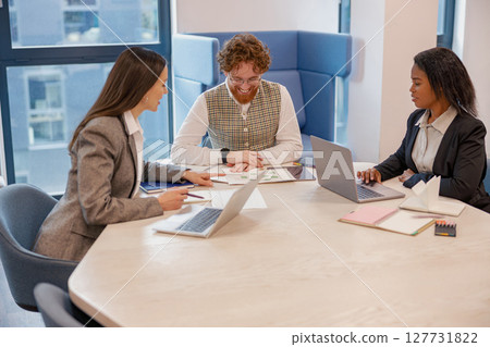 A Diverse Business Meeting Takes Place in a Modern Office Space Designed for Collaboration A Diverse Business Meeting Takes Place in a Modern Office Space Designed for Collaboration 127731822