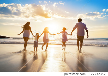 Family Enjoying a Fun Summer Vacation Together on the Beach at Sunset with Joyful Moments 127732357