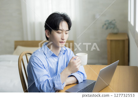 A young man using a computer A young man using a computer 127732553