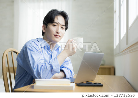 A young man using a computer 127732556