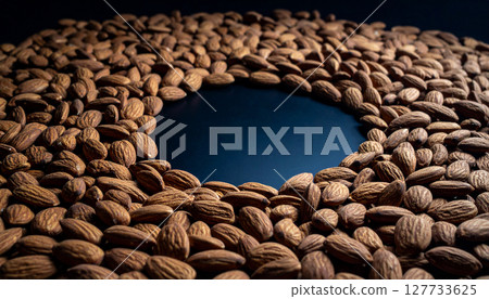 Tumbled raw almond background. Generated Image 127733625