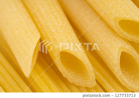 Close up of dried pasta spaghetti and penne rigate Close up of dried pasta spaghetti and penne rigate 127733713