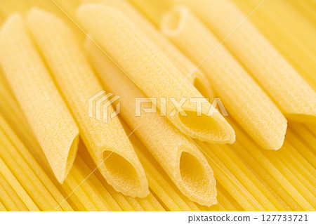 Close up of dried pasta spaghetti and penne rigate Close up of dried pasta spaghetti and penne rigate 127733721