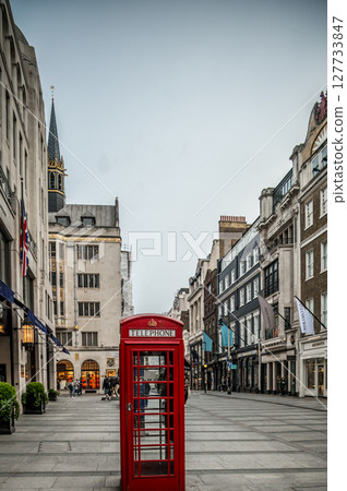 London Red Telephone Boxes on the Street. Black and White Buildings and Street with Red London Telephone Boxes 127733847