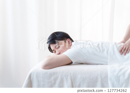 Aesthetician treating a customer 127734262