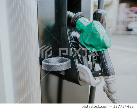 Green nozzle for diesel at a gas station Green nozzle for diesel at a gas station 127734452
