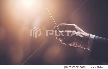 Close up of conducting hands warm lighting blurred background 127736620