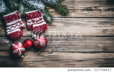 Snowy Christmas Mittens and Ornaments on Rustic Wooden Planks Ba Snowy Christmas Mittens and Ornaments on Rustic Wooden Planks Ba 127736817