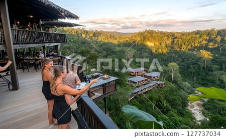 Family Enjoying Sunset View Over Rainforest Resort Family Enjoying Sunset View Over Rainforest Resort 127737034