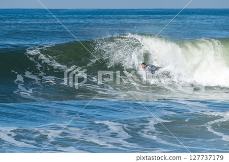 Bodyboarder surfing ocean wave Bodyboarder surfing ocean wave 127737179