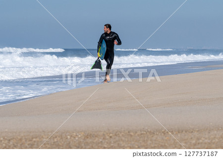 Bodyboarder running 127737187