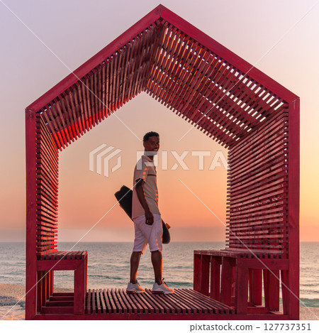 Surf skater on a beach 127737351