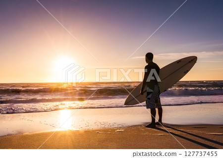 Surfer watching the waves 127737455
