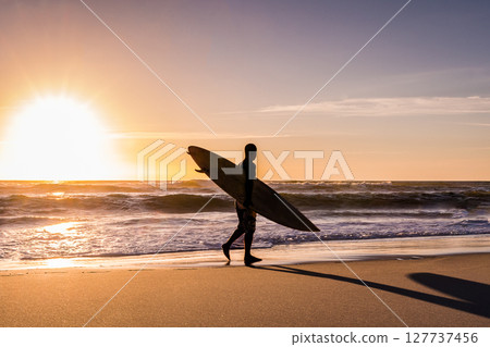Surfer watching the waves 127737456