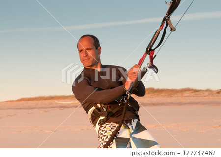 Kite surfer watching the waves Kite surfer watching the waves 127737462
