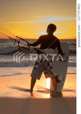 Kite surfer watching the waves Kite surfer watching the waves 127737463