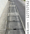 Sidewalk gutter cover and concrete texture 127737542