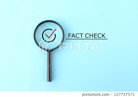 Check mark and fact check text in a magnifying glass Check mark and fact check text in a magnifying glass 127737571