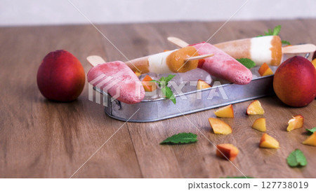 Homemade raspberries and peach popsicles Homemade raspberries and peach popsicles 127738019