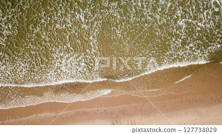 Ocean waves crashing on beach 127738029