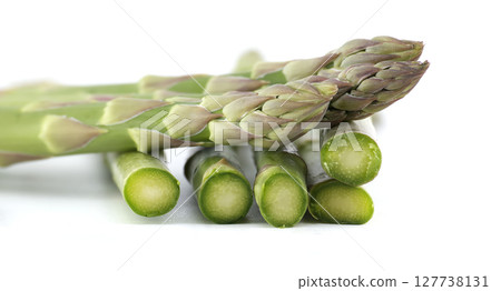 Close-up of fresh green asparagus, cut and whole, ready for a healthy meal. 127738131
