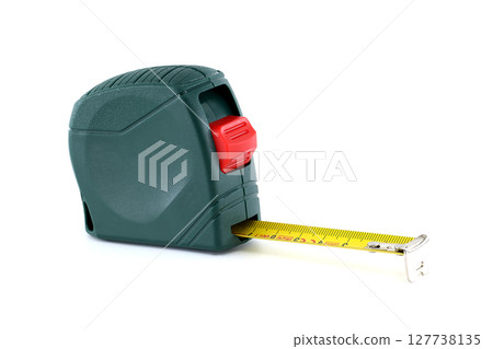 A green and red measuring tape extends on a white background, perfect for precise measurements. A green and red measuring tape extends on a white background, perfect for precise measurements. 127738135