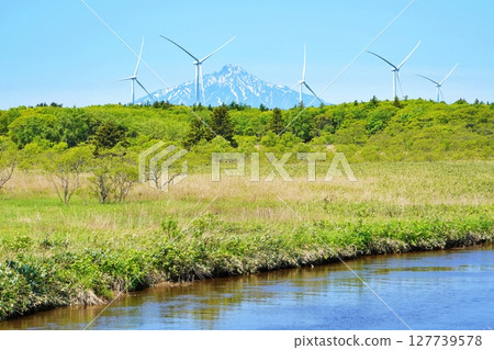 Summer in Hokkaido: Rishiri Fuji and windmills seen from the Sarobetsu Plains Summer in Hokkaido: Rishiri Fuji and windmills seen from the Sarobetsu Plains 127739578