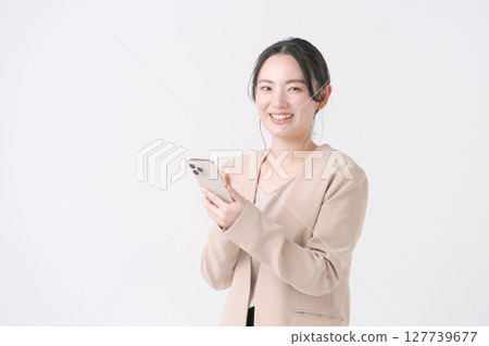 A woman with a suit with a smartphone 127739677