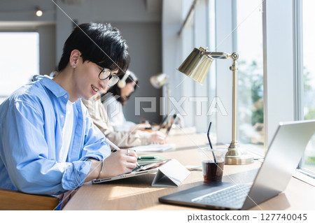 A man working at a cafe A man working at a cafe 127740045