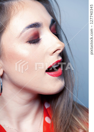 Woman with closed eyes and open mouth close-up studio portrait Woman with closed eyes and open mouth close-up studio portrait 127740345