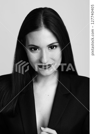 Beautiful woman with long dark hair and classic suit studio portrait 127740405