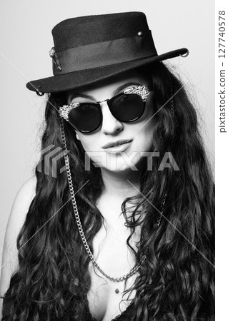 Beautiful woman with hat and sunglasses studio portrait Beautiful woman with hat and sunglasses studio portrait 127740578