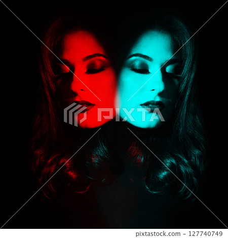 Beautiful woman portrait standing in darkness with illuminated face in RGB color split effect 127740749