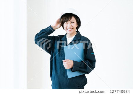 Senior woman in work clothes 127740984