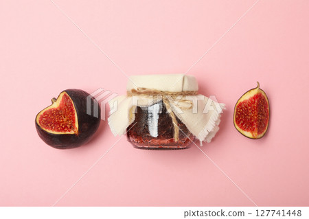 Figs and jar of jam on light pink background, top view Figs and jar of jam on light pink background, top view 127741448