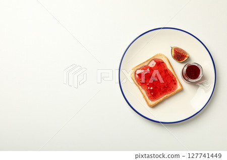 Figs, jam and piece of bread on plate on white background, space for text Figs, jam and piece of bread on plate on white background, space for text 127741449