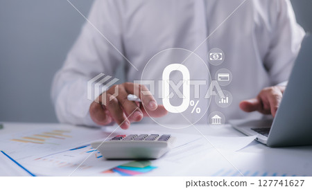 A person using a calculator and laptop with a prominent 0% icon overlay, representing zero interest rates, financial incentives, loan offers, and strategic cost management in banking and finance. 127741627