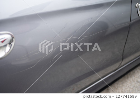 Grey car door with multiple long scratches Grey car door with multiple long scratches 127741689