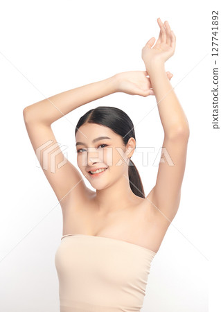 Beautiful Young Asian woman Raises her hands to Showcase clean and hygienic underarms Against a white background, Smooth armpit cleanliness and protection concept Beautiful Young Asian woman Raises her hands to Showcase clean and hygienic underarms Against a white background, Smooth armpit cleanliness and protection concept 127741892