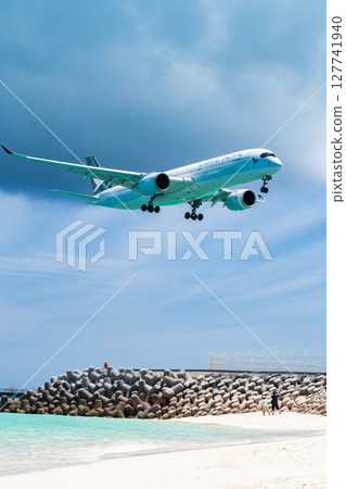 Large passenger plane landing on beach 127741940
