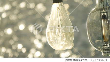 A nostalgic scene with the sparkling sea and fishing boats' fishing lights 127743601