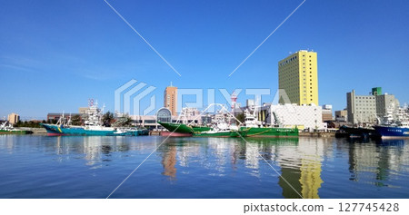 The harbor reflected on the water The harbor reflected on the water 127745428