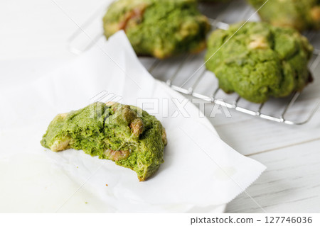 Closeup of fresh baked matcha cookies on white wooden background. Closeup of fresh baked matcha cookies on white wooden background. 127746036
