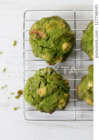Closeup of fresh baked matcha cookies on white wooden background. Closeup of fresh baked matcha cookies on white wooden background. 127746045